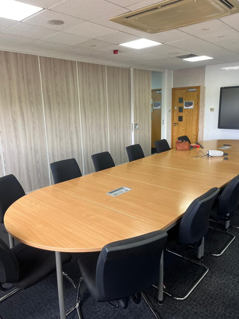 Completed meeting room renovation at Alstom's Barton site, featuring new room partition doors and an 8-meter sliding acoustic door for flexible space use.