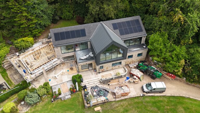 Building project update, Cloud Lodge, Ashbourne, Derbyshire. Showing 2 storey house with solar panels and standing seam roof with large front elevation picture window.
