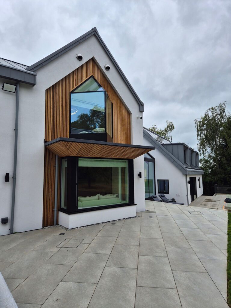 Contemporary house exterior featuring a bespoke glass oriel window design built by Allsopp Construction.
