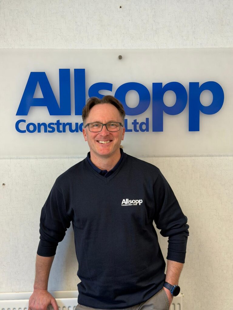 Steve Wooddisse, Contracts Manager at Allsopp Construction who joined the team in March 2026. Steve is of average height, short dark hair, glasses and is wearing a navy blue Allsopp Construction sweatshirt.