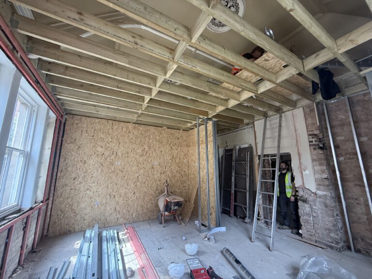 Old Liversage Trust Offices being converted. Photo shows stripped room with new sted walls and ceilings being built and MVHR system ducting being installed.