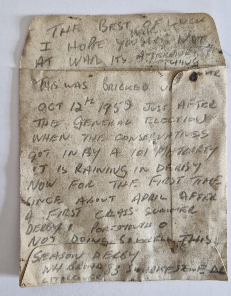 Handwritten note dated 12 October 1959 found hidden beneath a staircase during the refurbishment of The Liversage Trust almshouses in Derby. The weathered note records local events, the General Election and Derby County's football results.