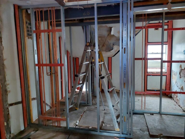 Metal studwork and first-fix plumbing being installed inside Block A of the Liversage Trust almshouses on London Road, Derby.